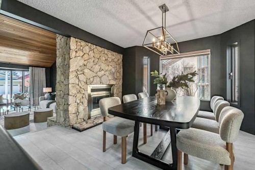 162 Woodbend Way, Okotoks, AB - Indoor Photo Showing Dining Room With Fireplace