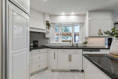 162 Woodbend Way, Okotoks, AB - Indoor Photo Showing Kitchen With Double Sink