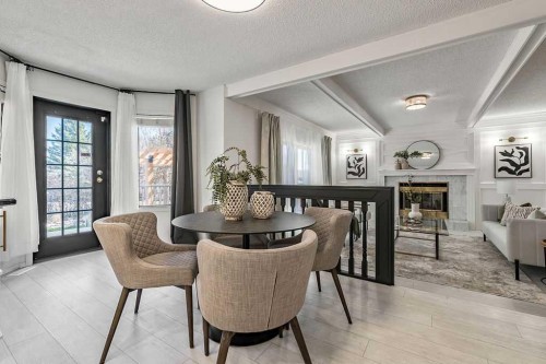 162 Woodbend Way, Okotoks, AB - Indoor Photo Showing Dining Room With Fireplace