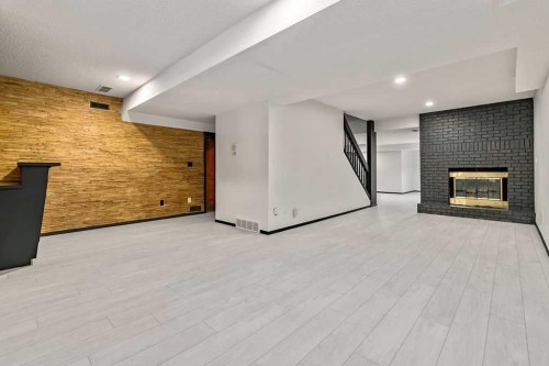 162 Woodbend Way, Okotoks, AB - Indoor With Fireplace