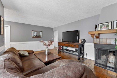 139 Hodson Crescent, Okotoks, AB - Indoor Photo Showing Living Room With Fireplace