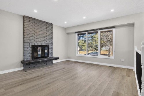 255 Rundleridge Drive Ne, Calgary, AB - Indoor Photo Showing Living Room With Fireplace
