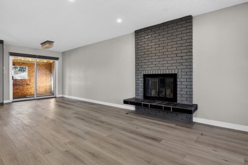 255 Rundleridge Drive Ne, Calgary, AB - Indoor Photo Showing Living Room With Fireplace