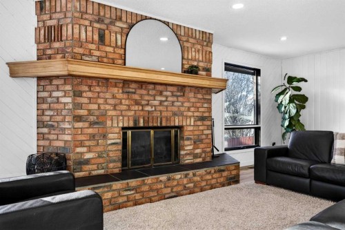 7103 Bow Crescent Nw, Calgary, AB - Indoor Photo Showing Living Room With Fireplace