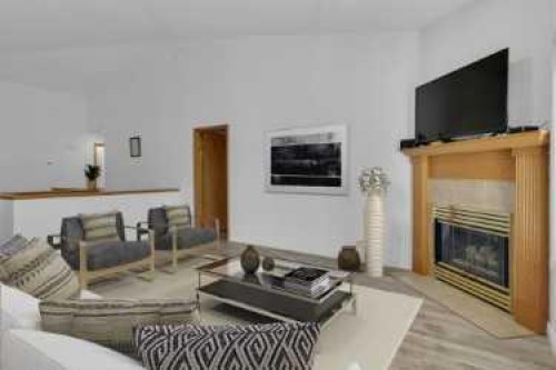 119 Edgepark Villas Nw, Calgary, AB - Indoor Photo Showing Living Room With Fireplace