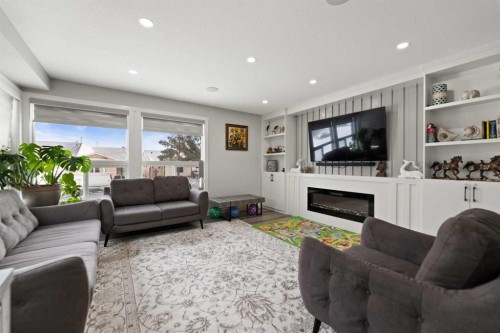 313 Falwood Way Ne, Calgary, AB - Indoor Photo Showing Living Room With Fireplace