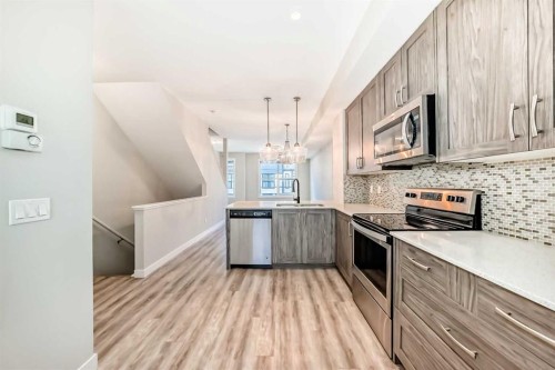 58-138 Seton Passage Se, Calgary, AB - Indoor Photo Showing Kitchen With Stainless Steel Kitchen With Double Sink With Upgraded Kitchen