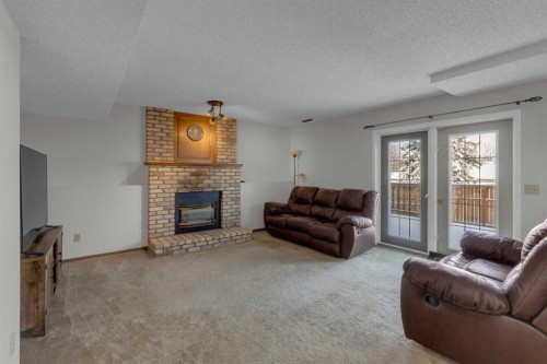 92 Macewan Drive Nw, Calgary, AB - Indoor Photo Showing Living Room With Fireplace