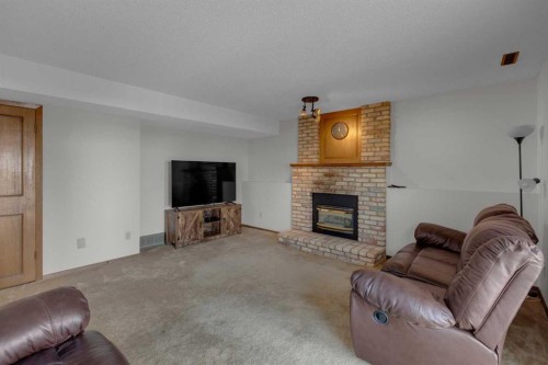 92 Macewan Drive Nw, Calgary, AB - Indoor Photo Showing Living Room With Fireplace
