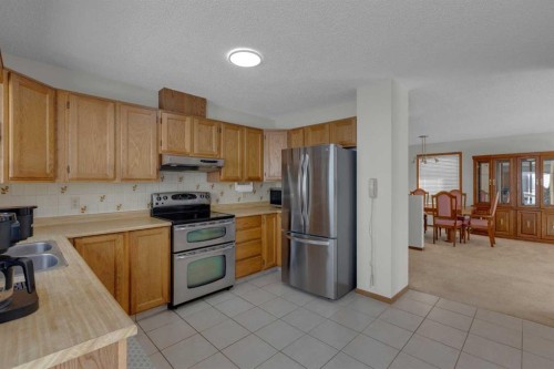92 Macewan Drive Nw, Calgary, AB - Indoor Photo Showing Kitchen With Stainless Steel Kitchen With Double Sink