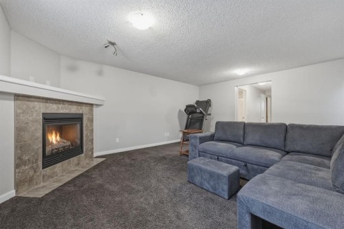 68 Auburn Bay Crescent Se, Calgary, AB - Indoor Photo Showing Living Room With Fireplace