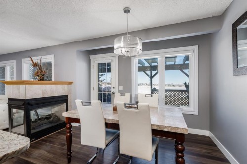 120 Hidden Ranch Crescent Nw, Calgary, AB - Indoor Photo Showing Dining Room With Fireplace