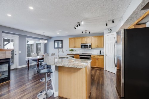 120 Hidden Ranch Crescent Nw, Calgary, AB - Indoor Photo Showing Kitchen With Fireplace