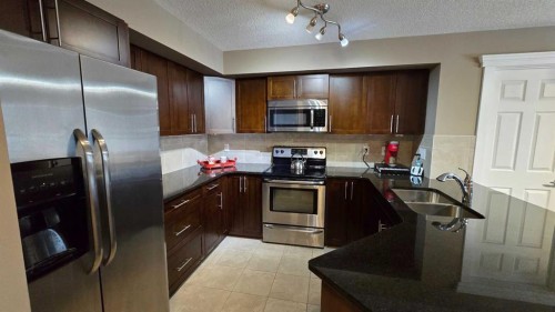128-500 Rocky Vista Gardens Nw, Calgary, AB - Indoor Photo Showing Kitchen With Stainless Steel Kitchen With Double Sink