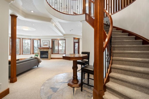 48 Coulee Park Sw, Calgary, AB - Indoor Photo Showing Other Room With Fireplace