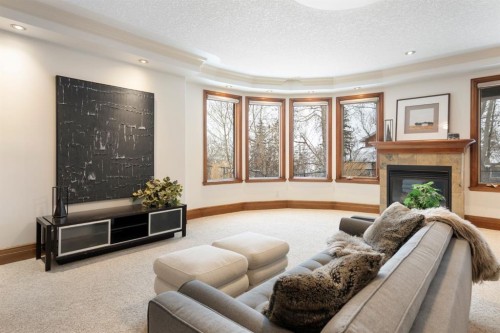 48 Coulee Park Sw, Calgary, AB - Indoor Photo Showing Living Room With Fireplace