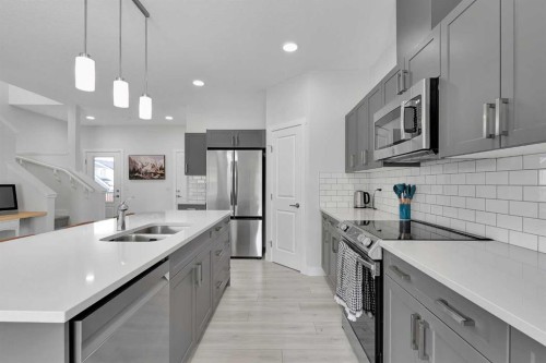 59 Belgian, Cochrane, AB - Indoor Photo Showing Kitchen With Stainless Steel Kitchen With Double Sink With Upgraded Kitchen