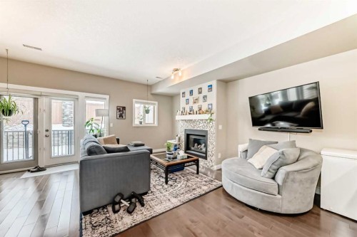 106 Cougar Ridge Landing Sw, Calgary, AB - Indoor Photo Showing Living Room With Fireplace