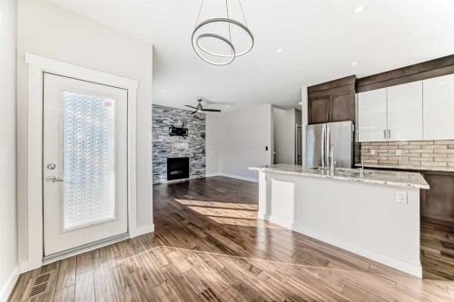 9 Saddlecrest Crescent Ne, Calgary, AB - Indoor Photo Showing Kitchen With Fireplace With Double Sink