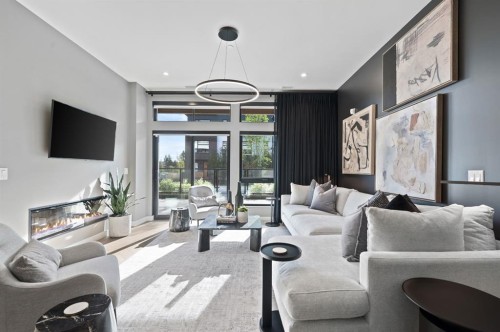 206-835 78 Street Sw, Calgary, AB - Indoor Photo Showing Living Room With Fireplace