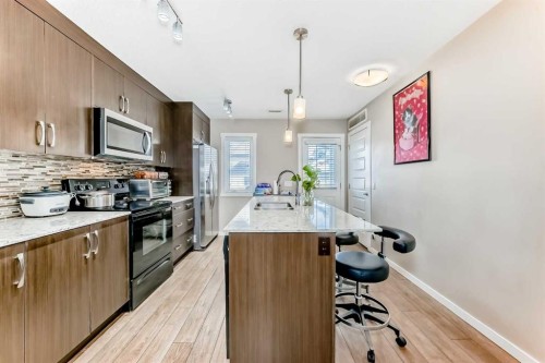 38 Auburn Bay Link Se, Calgary, AB - Indoor Photo Showing Kitchen With Double Sink With Upgraded Kitchen