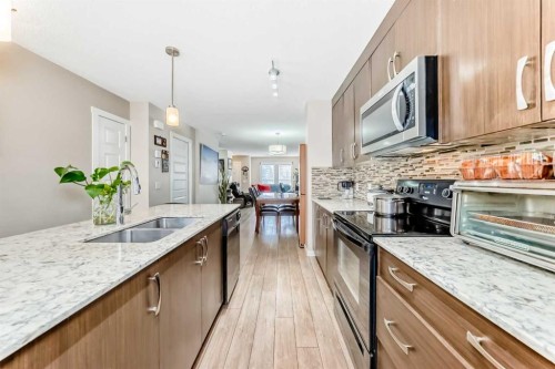 38 Auburn Bay Link Se, Calgary, AB - Indoor Photo Showing Kitchen With Double Sink With Upgraded Kitchen
