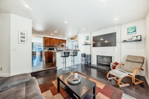 208 Woodbine Boulevard Sw, Calgary, AB - Indoor Photo Showing Living Room With Fireplace