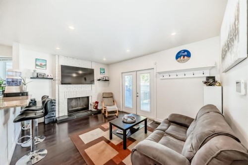 208 Woodbine Boulevard Sw, Calgary, AB - Indoor Photo Showing Living Room With Fireplace