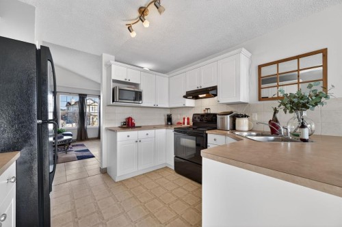 131 Covepark Place Ne, Calgary, AB - Indoor Photo Showing Kitchen With Double Sink