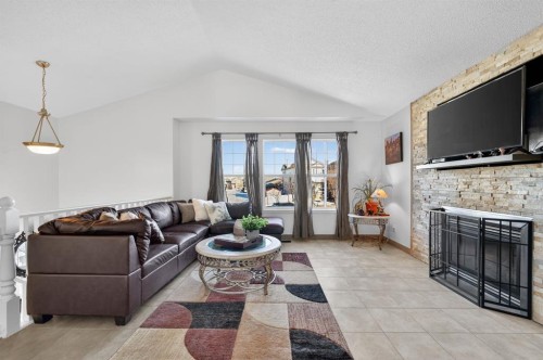 131 Covepark Place Ne, Calgary, AB - Indoor Photo Showing Living Room With Fireplace