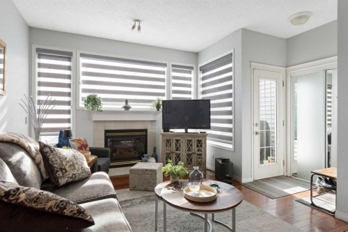 25 Promenade Way Se, Calgary, AB - Indoor Photo Showing Living Room With Fireplace