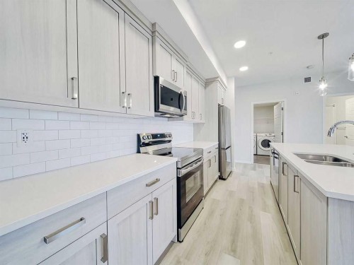 2412-220 Seton Grove Se, Calgary, AB - Indoor Photo Showing Kitchen With Stainless Steel Kitchen With Double Sink With Upgraded Kitchen
