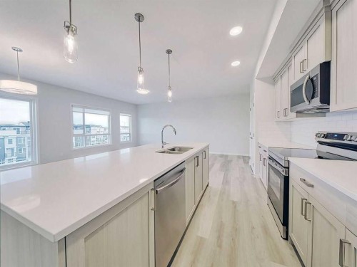 2412-220 Seton Grove Se, Calgary, AB - Indoor Photo Showing Kitchen With Stainless Steel Kitchen With Double Sink With Upgraded Kitchen