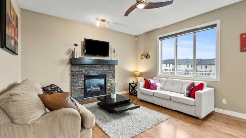 153 Heritage Bay, Cochrane, AB - Indoor Photo Showing Living Room With Fireplace