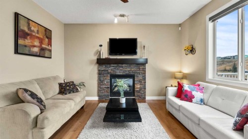 153 Heritage Bay, Cochrane, AB - Indoor Photo Showing Living Room With Fireplace