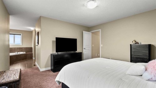 153 Heritage Bay, Cochrane, AB - Indoor Photo Showing Bedroom