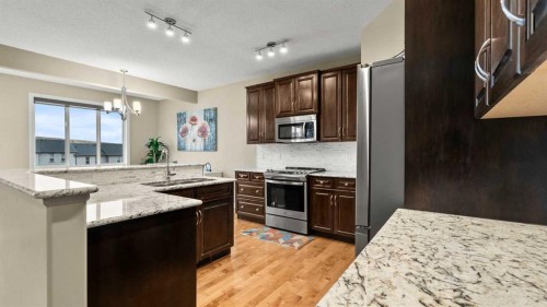 153 Heritage Bay, Cochrane, AB - Indoor Photo Showing Kitchen With Stainless Steel Kitchen