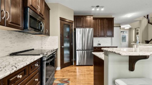 153 Heritage Bay, Cochrane, AB - Indoor Photo Showing Kitchen With Stainless Steel Kitchen With Upgraded Kitchen