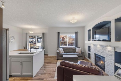 729 Hampton Hills Drive Ne, High River, AB - Indoor Photo Showing Living Room With Fireplace