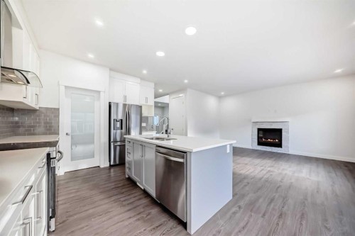 772 Edgefield Crescent, Strathmore, AB - Indoor Photo Showing Kitchen With Fireplace With Stainless Steel Kitchen With Double Sink With Upgraded Kitchen