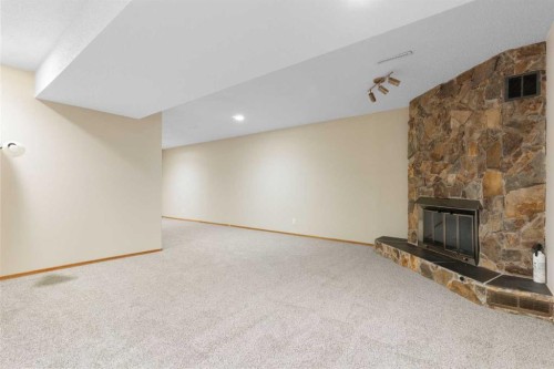 123 Glacier Drive Sw, Calgary, AB - Indoor Photo Showing Other Room With Fireplace