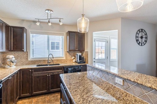 100 Silverado Plains View Sw, Calgary, AB - Indoor Photo Showing Kitchen With Double Sink With Upgraded Kitchen