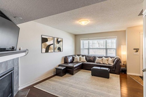 100 Silverado Plains View Sw, Calgary, AB - Indoor Photo Showing Living Room With Fireplace