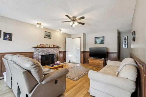144 Waldron Avenue, Okotoks, AB - Indoor Photo Showing Living Room With Fireplace