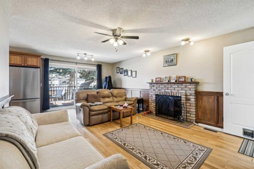144 Waldron Avenue, Okotoks, AB - Indoor Photo Showing Living Room With Fireplace