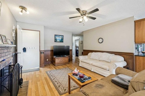 144 Waldron Avenue, Okotoks, AB - Indoor Photo Showing Living Room With Fireplace