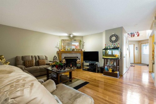 332 Harvest Hills Drive Ne, Calgary, AB - Indoor Photo Showing Living Room With Fireplace
