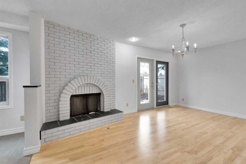 815 Woodpark Way Sw, Calgary, AB - Indoor Photo Showing Other Room With Fireplace