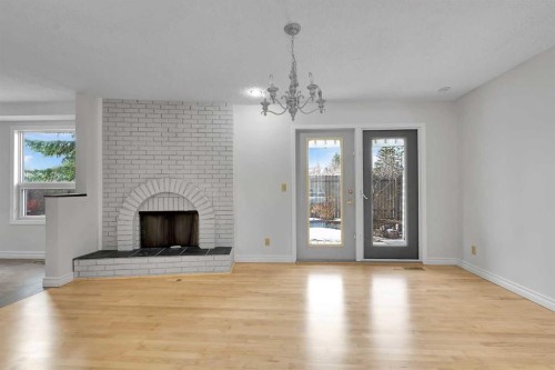 815 Woodpark Way Sw, Calgary, AB - Indoor Photo Showing Living Room With Fireplace