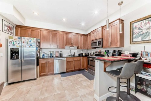 210-1005A Westmount Drive, Strathmore, AB - Indoor Photo Showing Kitchen With Stainless Steel Kitchen